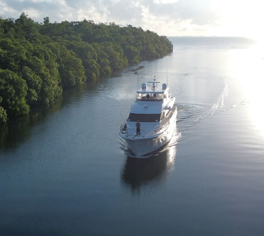 The project's 47-foot yacht cruising the Sittee River at golden hour
